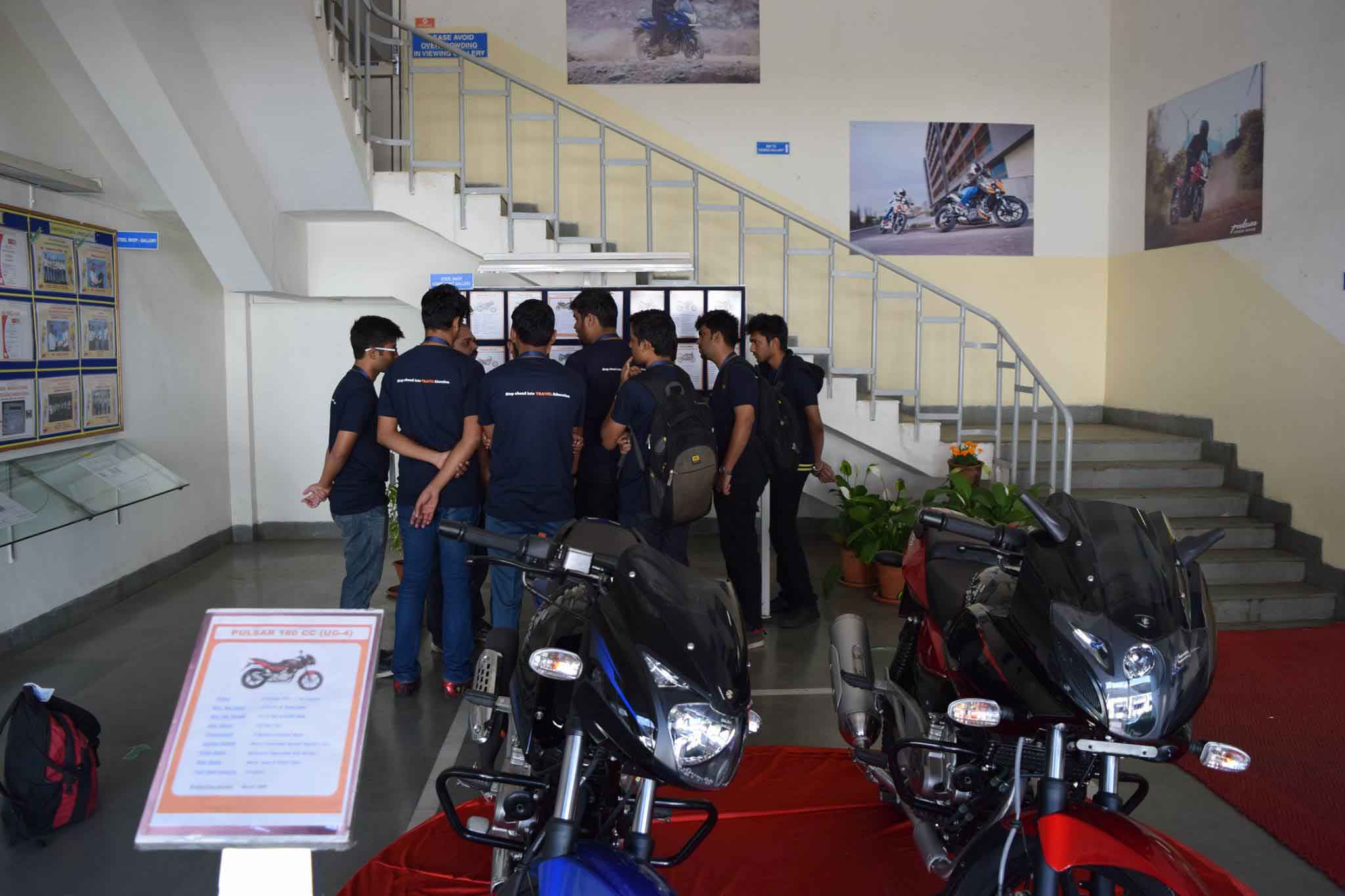 Enthusiastic students discussing at the Bajaj Auto plant.
