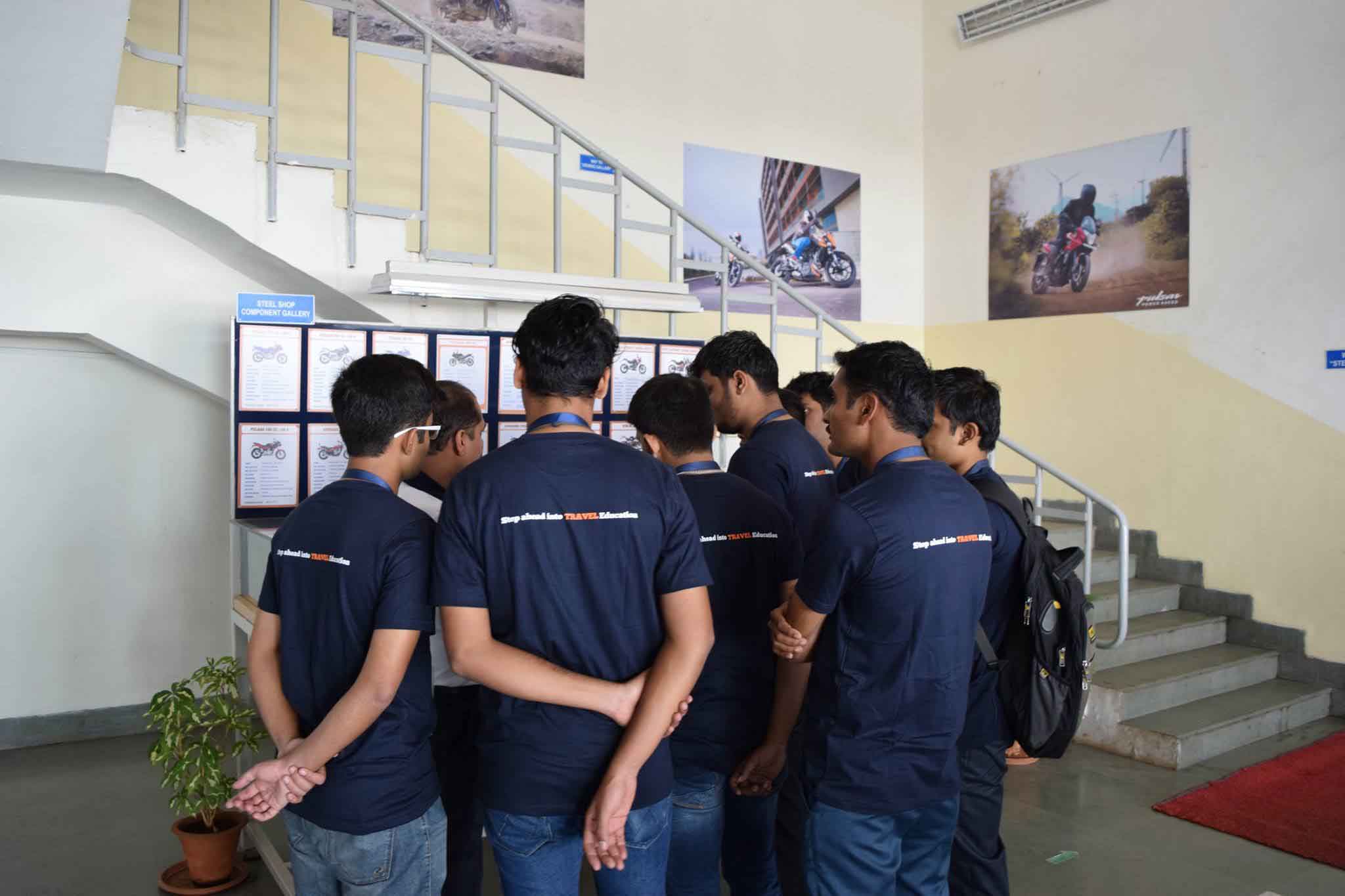 Enthusiastic students discussing at the Bajaj Auto plant.